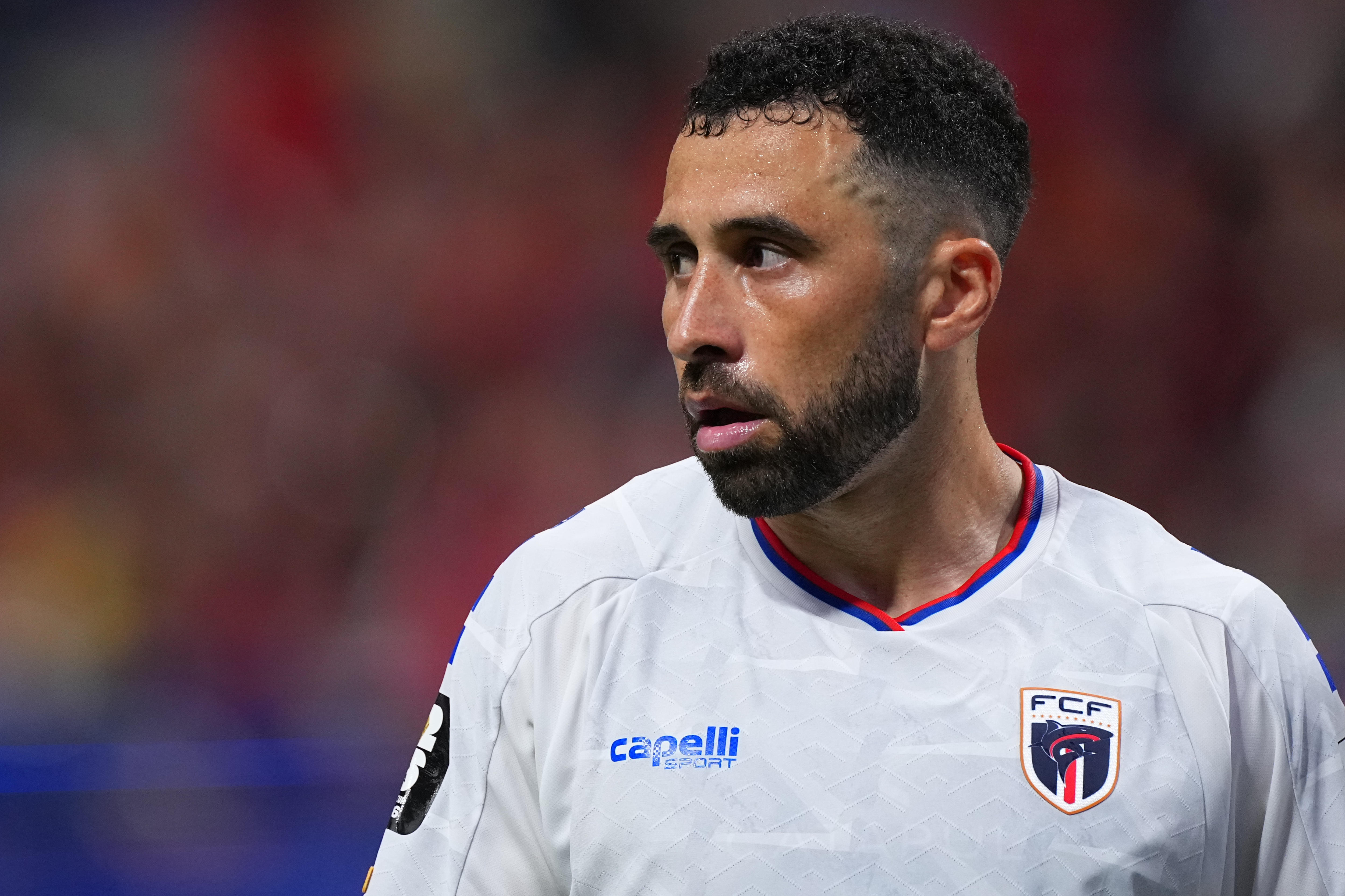 Roberto Lopes looks to one side