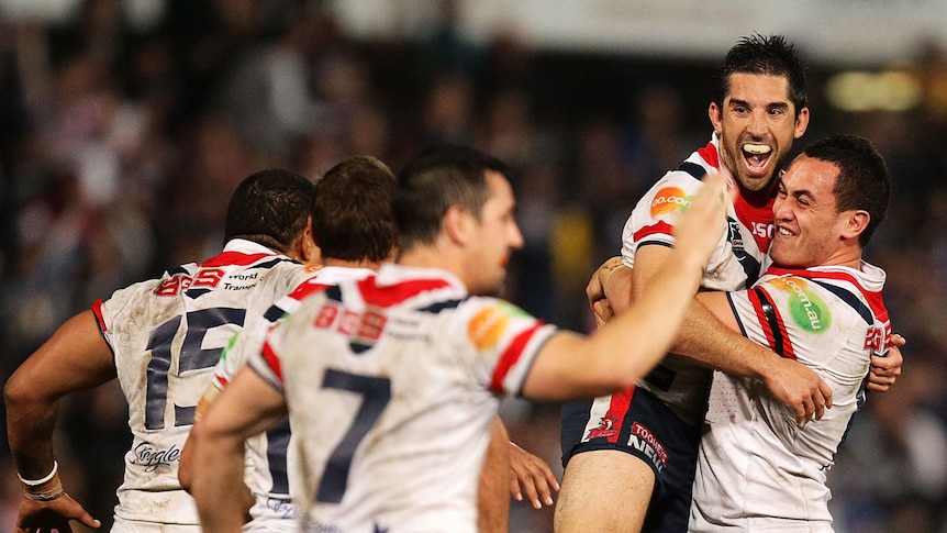 Golden boy ... the Roosters celebrate Braith Anasta's game-winning field goal.