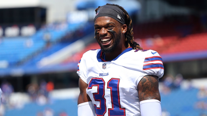 A football player smiles.