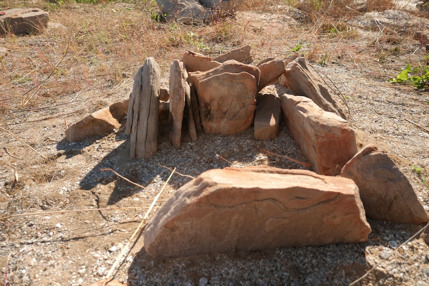 A stone firepit on a beach 