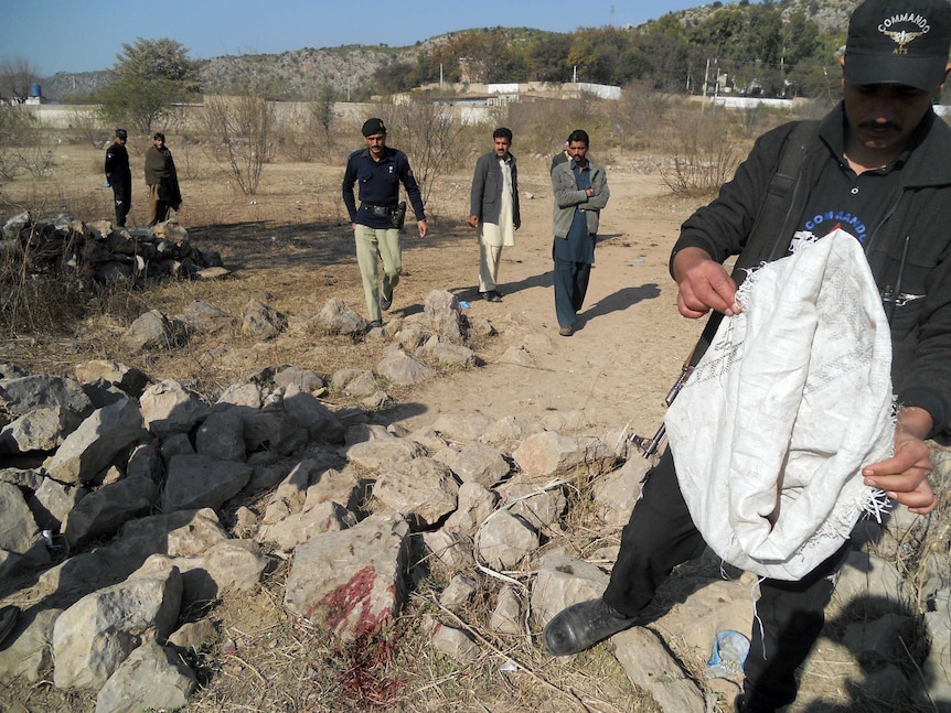 Pakistani security personnel examine the site of a suicide bombing in the Ibrahimzai area of Hangu district.