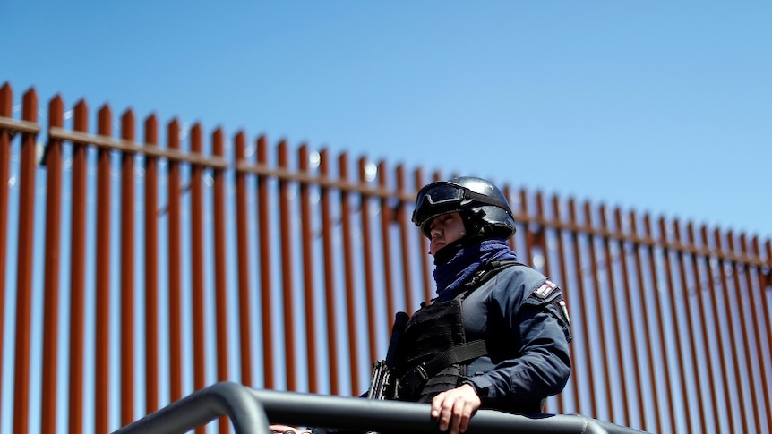 Mexican federal police guarded the wall ahead of Mr Trump's visit.