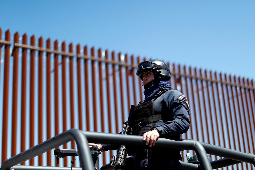 Mexican federal police guarded the wall ahead of Mr Trump's visit.