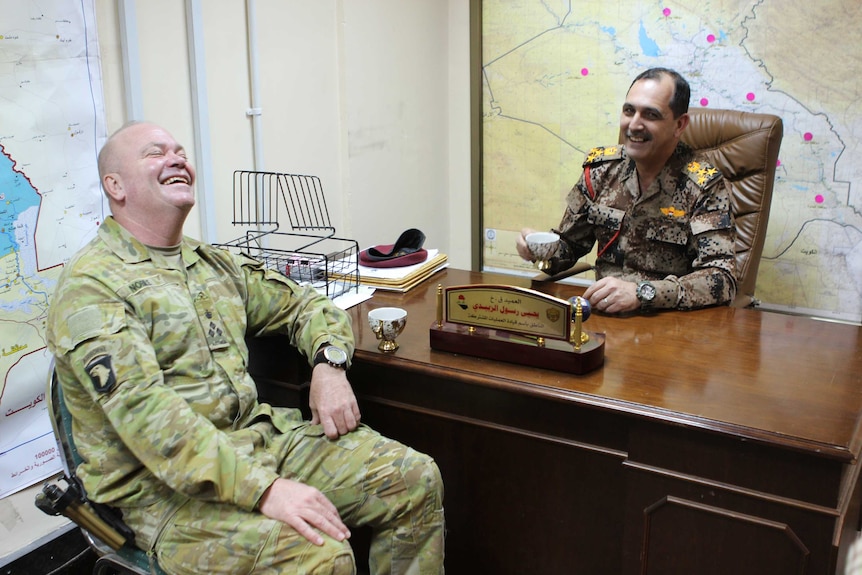 The two officers drink tea.