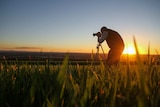 Kingaroy resident John Dalton takes a photo of the landscape in Kingaroy region in southern Queensland at sunset