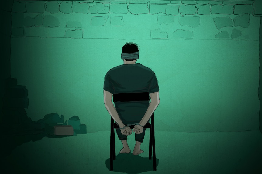 An illustration of a man sitting on a chair facing a wall with his hands tied behind his back..