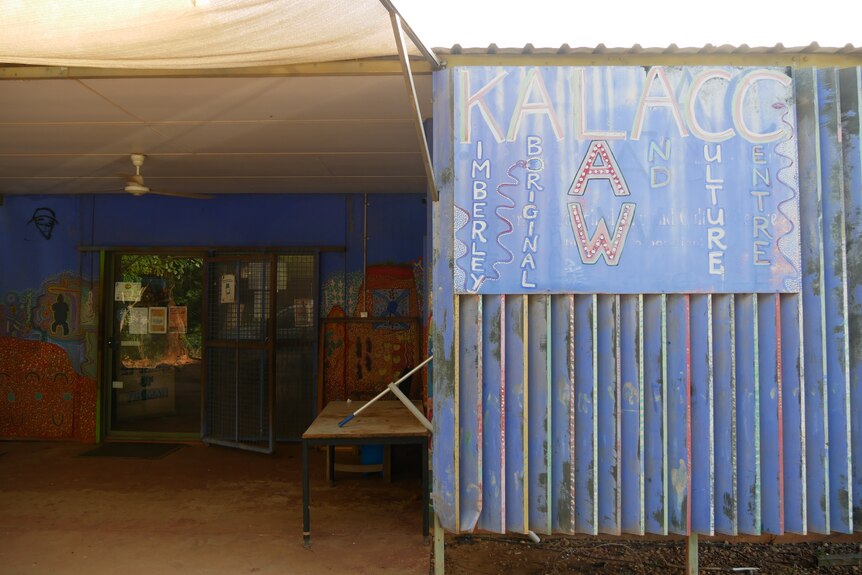 A blue sign on a metal shed with "Kimberley Aboriginal Law and Culture Centre" written in colourful letters.