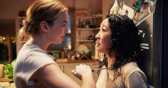 Screenshot from TV show Killing Eve where Jodie Comer's character, Villanelle, holds knife to Sanda Oh's character, Eve.