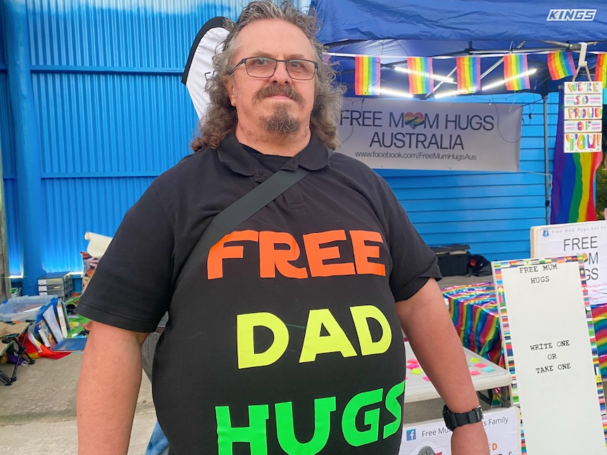 Man wearing a Free Dad Hugs shirt