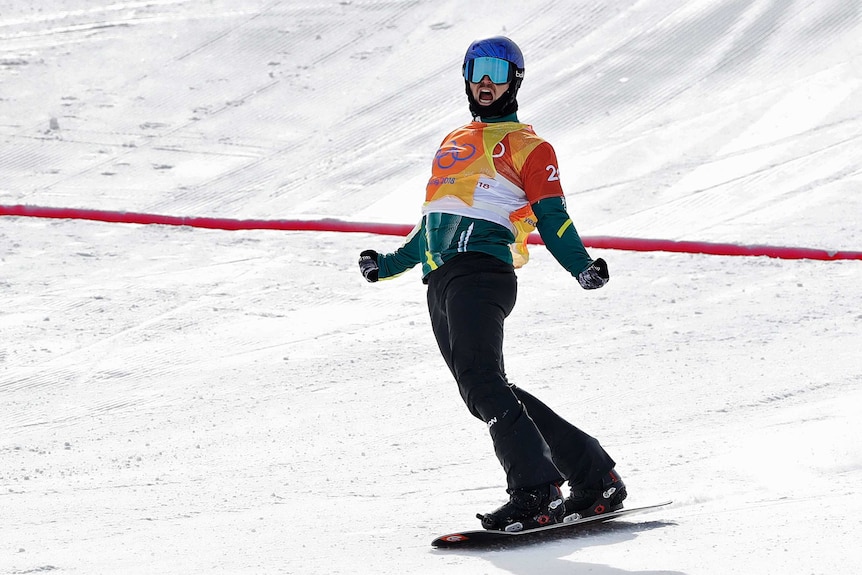 Alex Pullin celebrates after his run in the snowboard cross semifinals