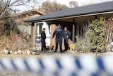 Forensics officers outside the house.