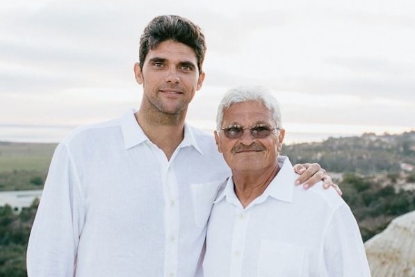 Mark Philippoussis poses with his arm around his father Nikolaos. They are both wearing white shirts