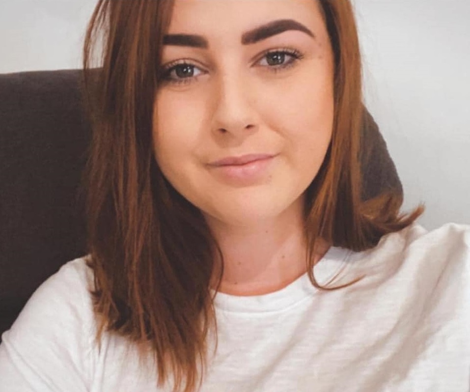 A woman smiles at the camera.