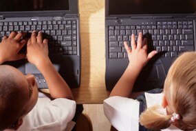 File photo: Boy and girl using laptops side by side (Getty Creative Images)