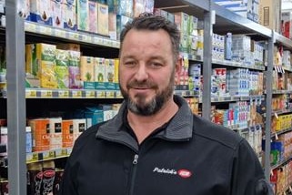 A man standing in a supermarket.