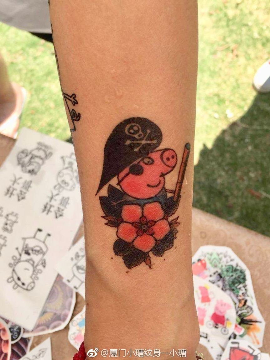 Pirate Peppa Pig fake tattoo. She has a skull and crossbones hat, an eye patch and appears to be on a boat.