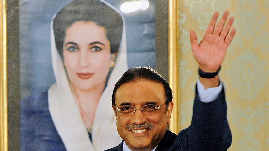 Pakistan's president Asif Ali Zardari stands in front of a portrait of his slain wife Benazir Bhutto in September 2008.