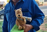 Grazier Mitch Rodgers and teddy bear 'Pooh' pose for a photo