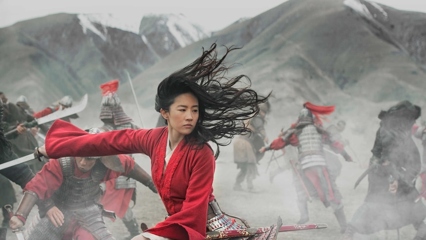 Liu Yifei as Mulan, a woman fighting with a sword, in the Disney movie Mulan