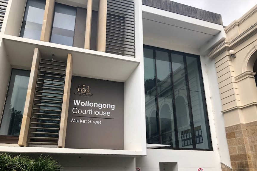 The facade of a modern-looking building with a sign that reads "Wollongong Court House".