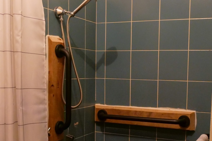 A shower with rails in it for an NDIS participant 