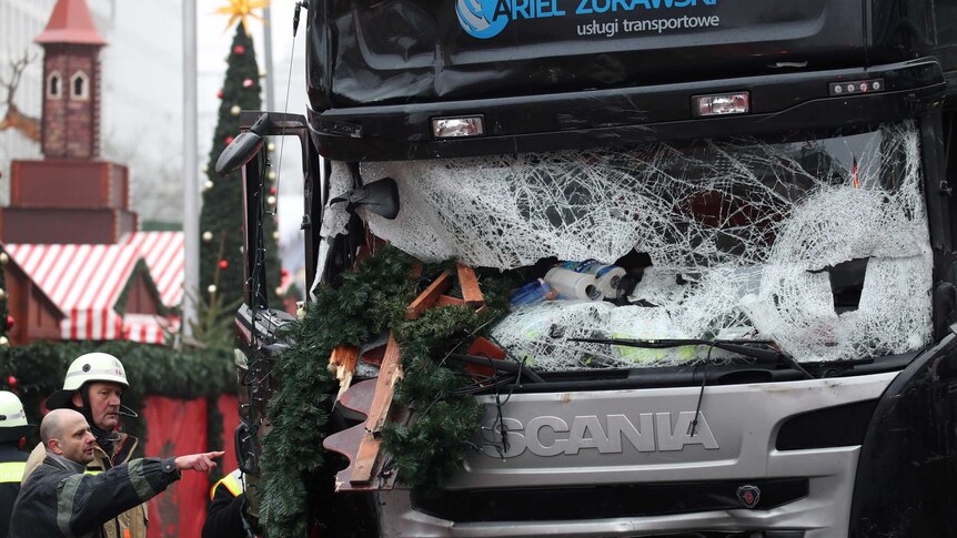 Firefighters point at bus that rammed Christmas market in Berlin