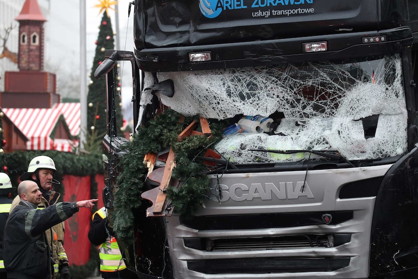 Firefighters point at bus that rammed Christmas market in Berlin