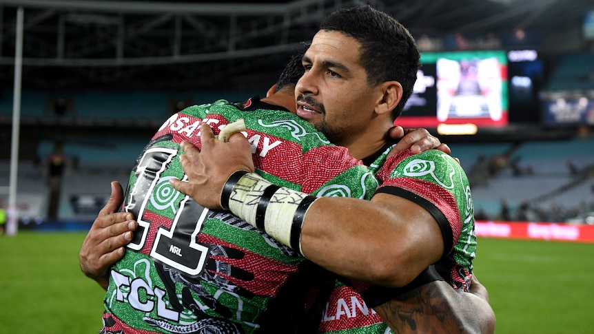 Rugby league player hugging a teammate after a match