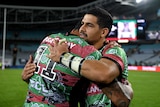 Rugby league player hugging a teammate after a match