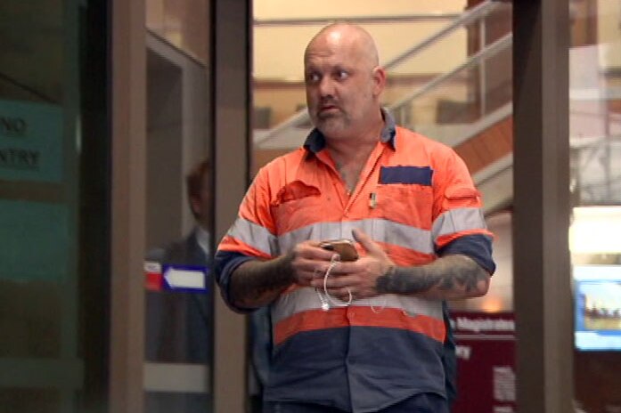 Jared Pihlgren walking out the doors at the Melbourne Magistrates' Court.