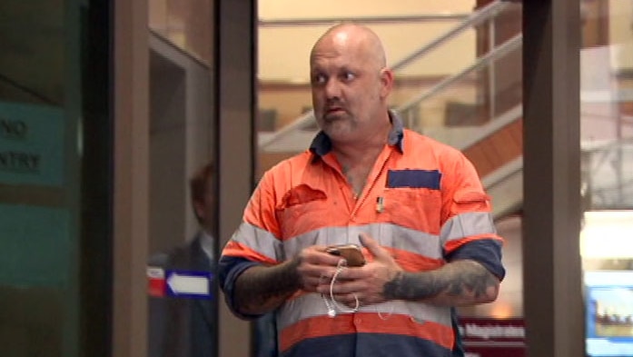 Jared Pihlgren walking out the doors at the Melbourne Magistrates' Court.