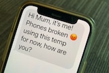 A phone displaying a text that reads "hi Mum, it's me! Phones broken. Using this temp for now, how are you?"