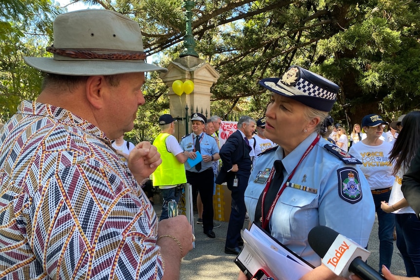 Police Commissioner Katarina Carroll speaks to a man while in her police uniform