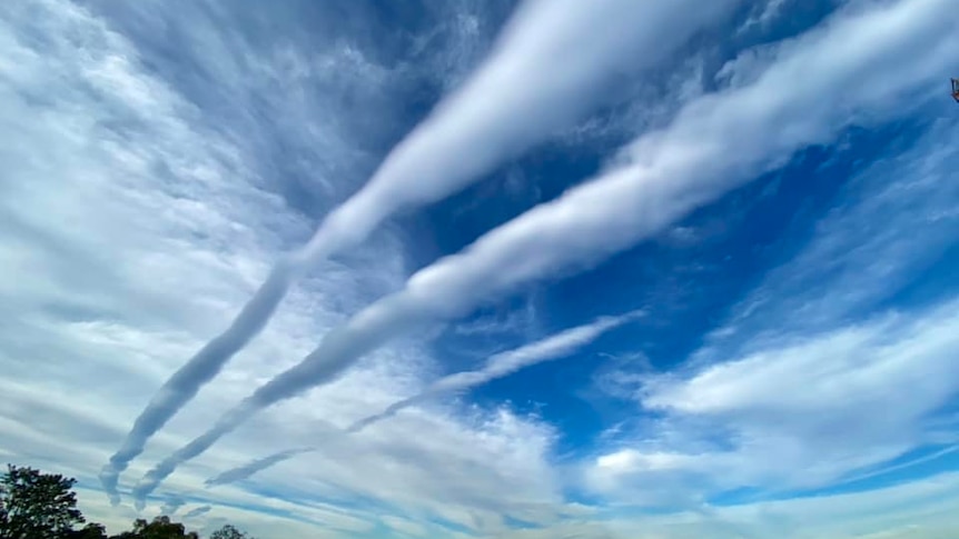 A series of roll clouds in the sky.