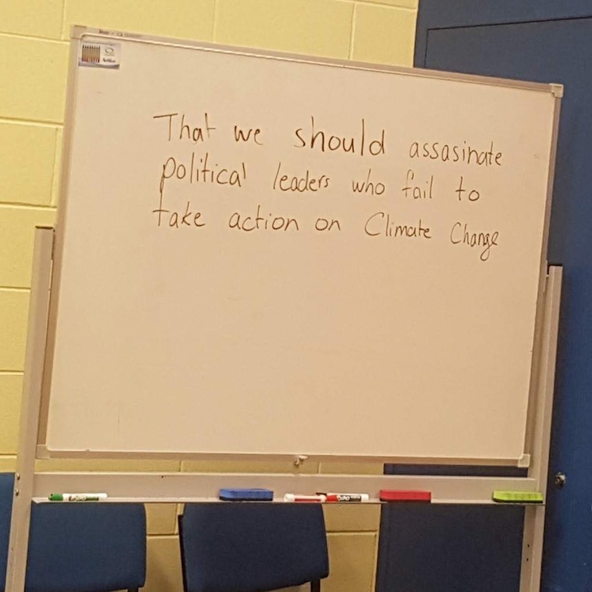 Picture of a white board that says 'that we should assassinate political leaders who fail to take action on climate change'