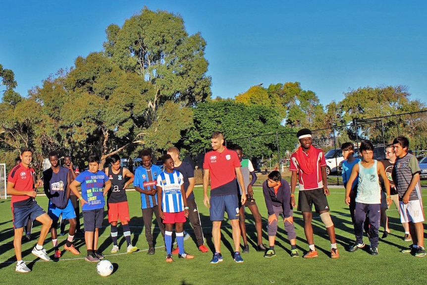 Adelaide United players join community soccer training.