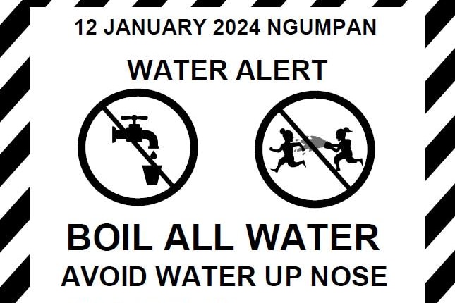 A black and white warning poster that reads "Boil all water".