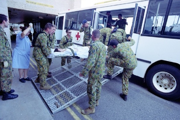 adf personnel transporting patients victims of the attacks in bali