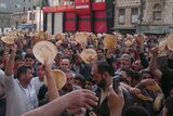Syrians hold bread during political rally