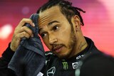 Lewis Hamilton scratches his forehead in disbelief after the controversial race outcome in Abu Dhabi