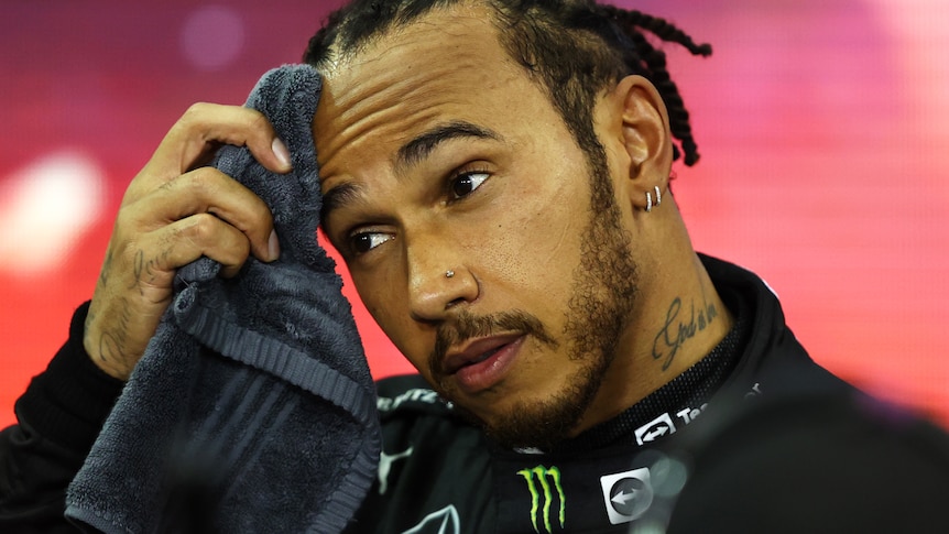 Hamilton wipes his forehead after the race.