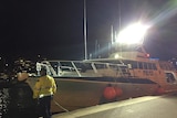 Police boat at Hobart wharf at night