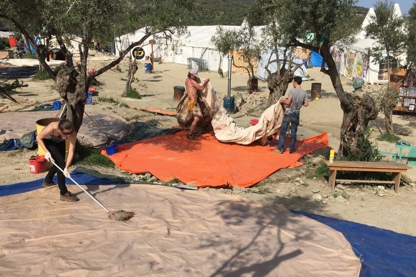 Volunteers help pack up at a former camp on Lesbos