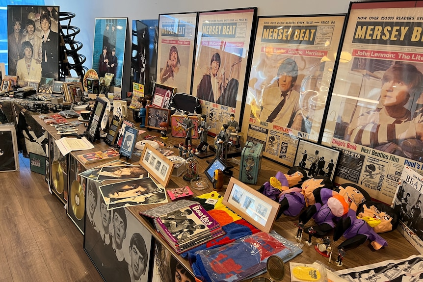 A long table covered in Beatles memorabilia.