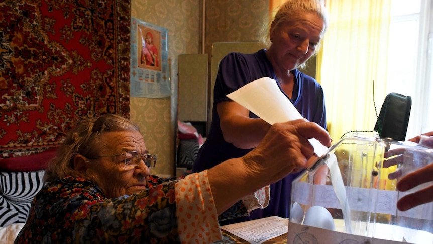 Elderly woman casting her vote