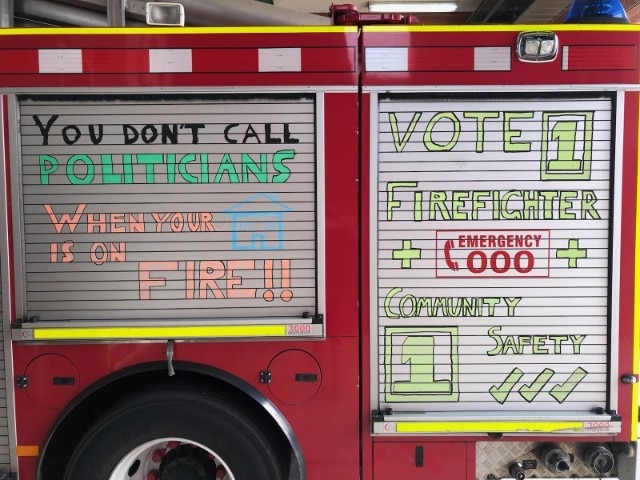 A fire truck bearing the slogan "You don't call politicians when your house is on fire".