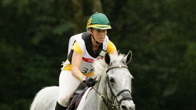 Megan Jones of Australia riding Irish Jester clears a jump during the Eventing Cross Country event