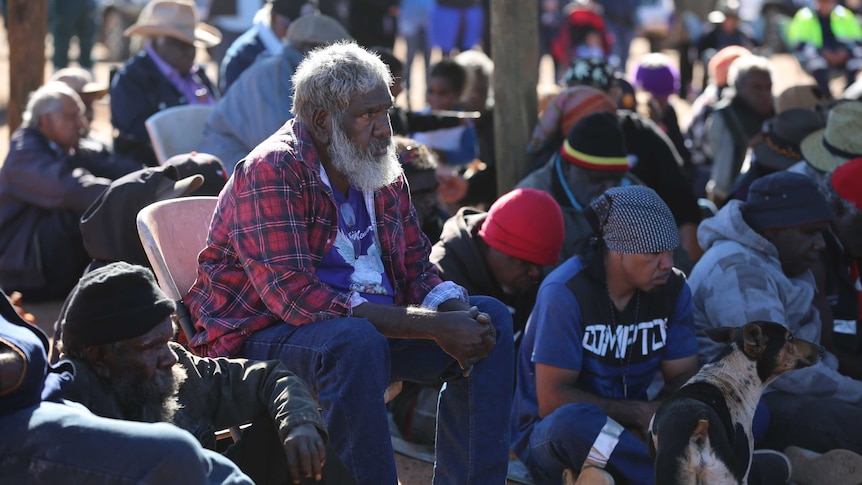 Jigalong elder Brian Samson sits among mourners at Daisy Kadibil's funeral.