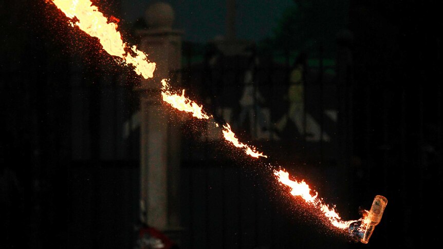 A molotov cocktail is thrown in , Jakarta, Indonesia, during clashes against plans to raise fuel prices.