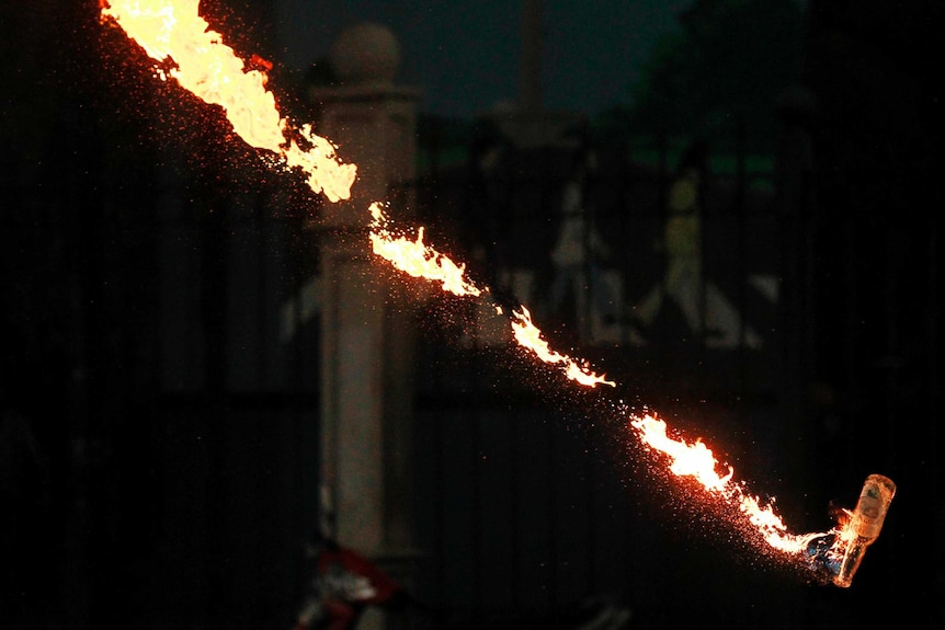 A molotov cocktail is thrown in , Jakarta, Indonesia, during clashes against plans to raise fuel prices.
